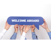 hands hold up a sign that says welcome aboard