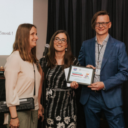 From left to right Ioana Gandrabur and Jessica Desormeaux from CELA present a plaque to Mathieu Tremblay who stands to their right.