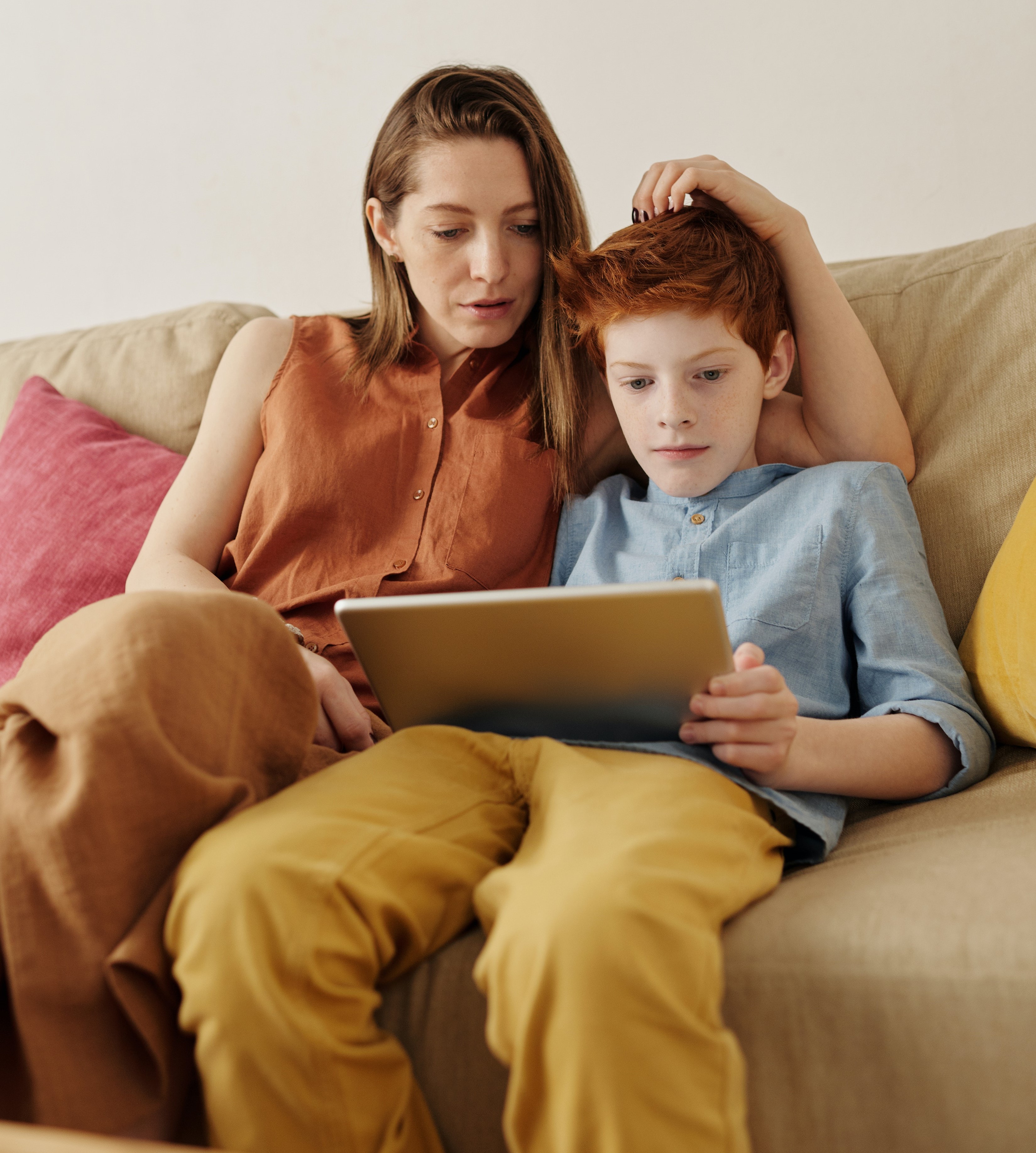 Woman and boy reading tablet