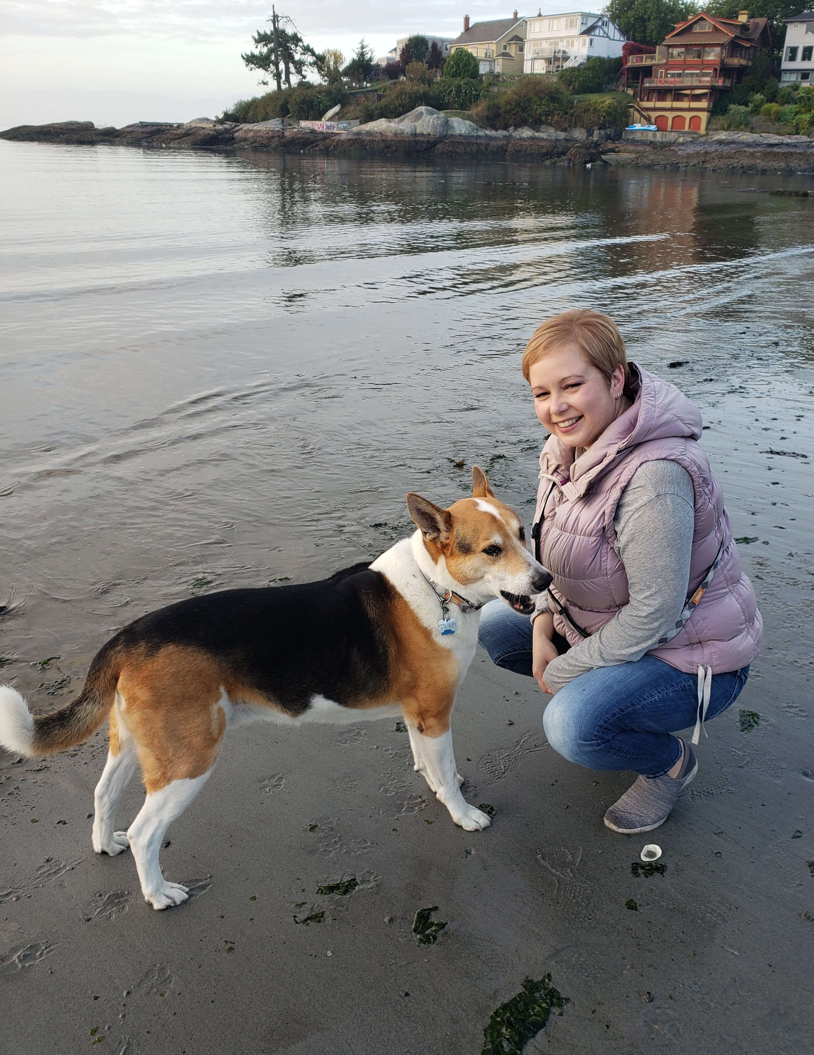 Rina and her dog Duke on a beach in Victoria