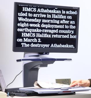 CCTV - Print Magnifier showing white enlarged text on a black screen