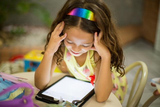 Child reading from iPad