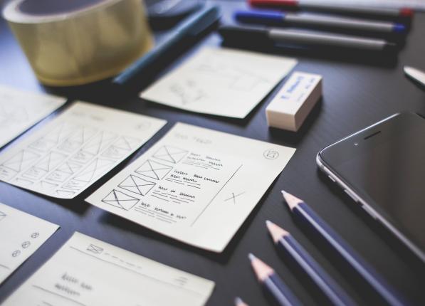Papers, pencils and a cell phone on a desk