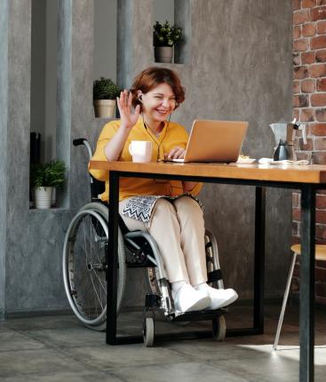Woman using wheelchair doing a videoconference