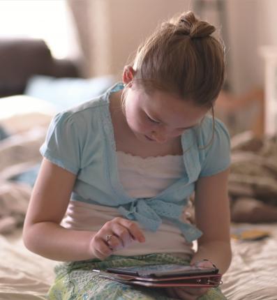 Girl reading on tablet