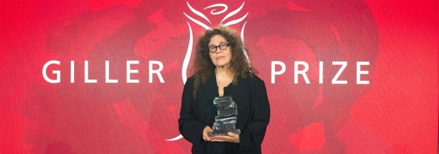 Photograph of 2024 Giller Prize winner Ann Michaels holding her prize statue