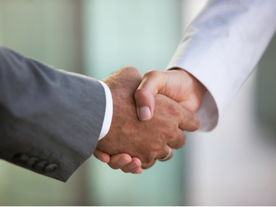 Close up photo of two people shaking hands.
